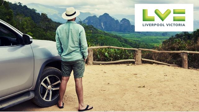 Man standing in the front of his car looking at the view